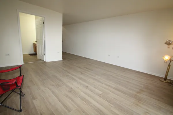a view of a room with wooden floor and bathroom