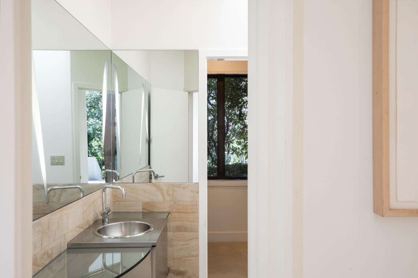 140 Degas Road Portola Valley, CA 94028 - Photo 11 of 31 a bathroom with a granite countertop sink and a large mirror