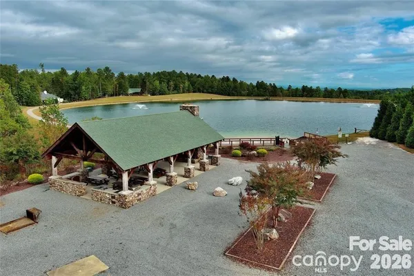 an aerial view of a house with a garden and lake view