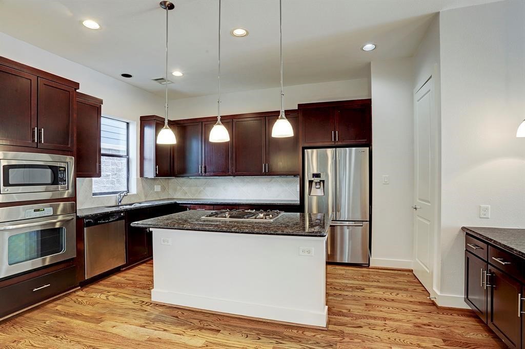 1203 Detering Street Houston, TX 77007 - Photo 1 of 14 Island kitchen with contemporary lighting and shining appliances