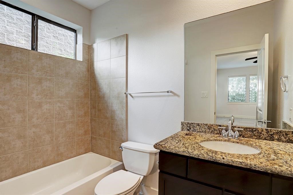1203 Detering Street Houston, TX 77007 - Photo 12 of 15 a bathroom with a granite countertop sink toilet and shower