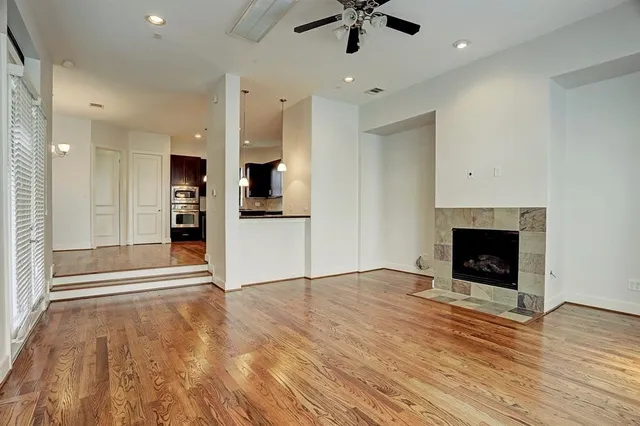 a bathroom with a granite countertop bathtub a sink and a window