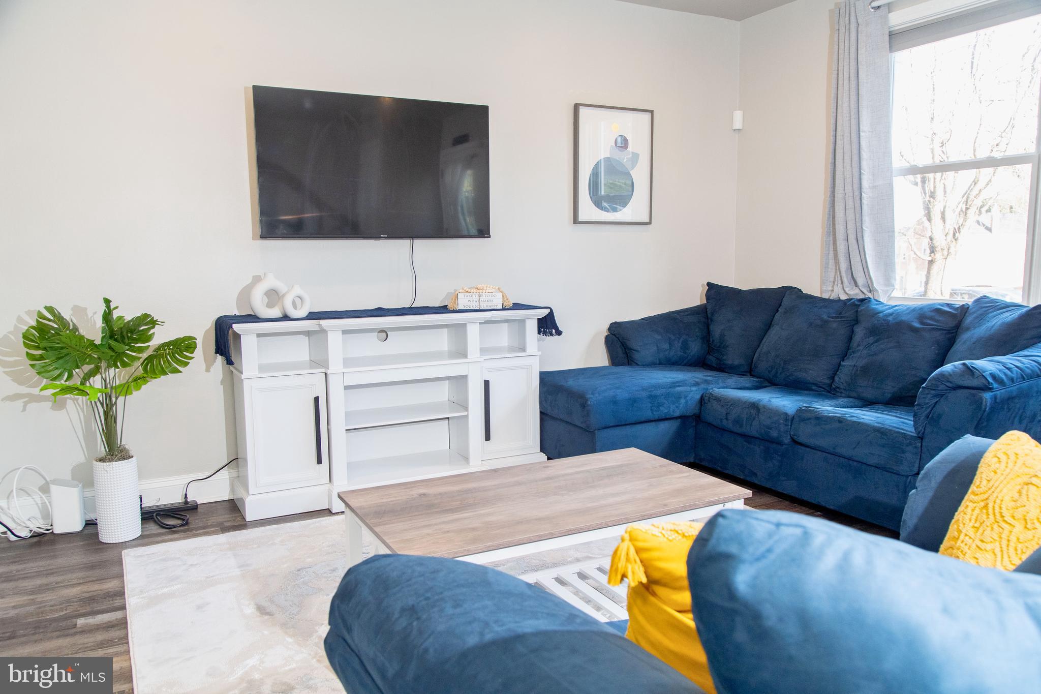 518 Random Road Baltimore, MD 21229 - Photo 1 of 29 a living room with furniture and a flat screen tv