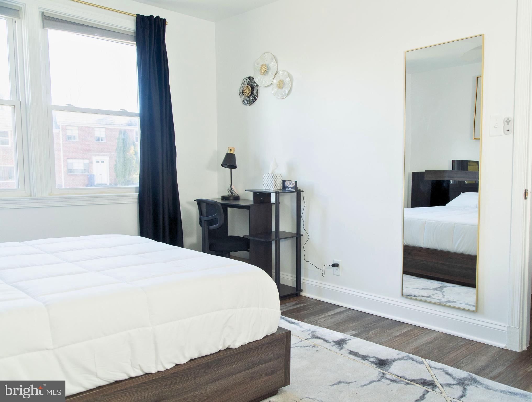 518 Random Road Baltimore, MD 21229 - Photo 12 of 29 a bedroom with a bed and a window with outer view