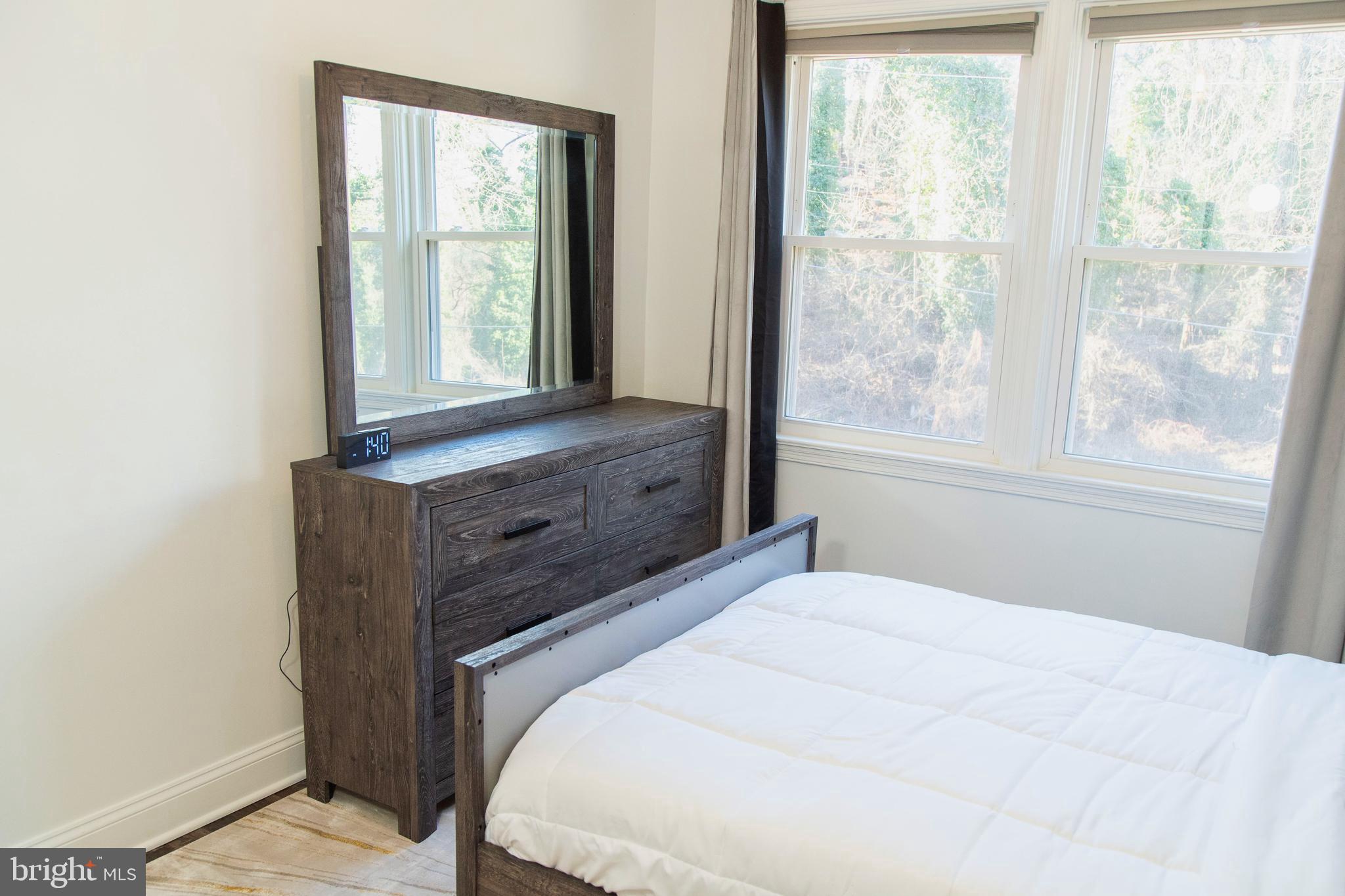 518 Random Road Baltimore, MD 21229 - Photo 16 of 29 a large bed sitting in a bedroom next to a window