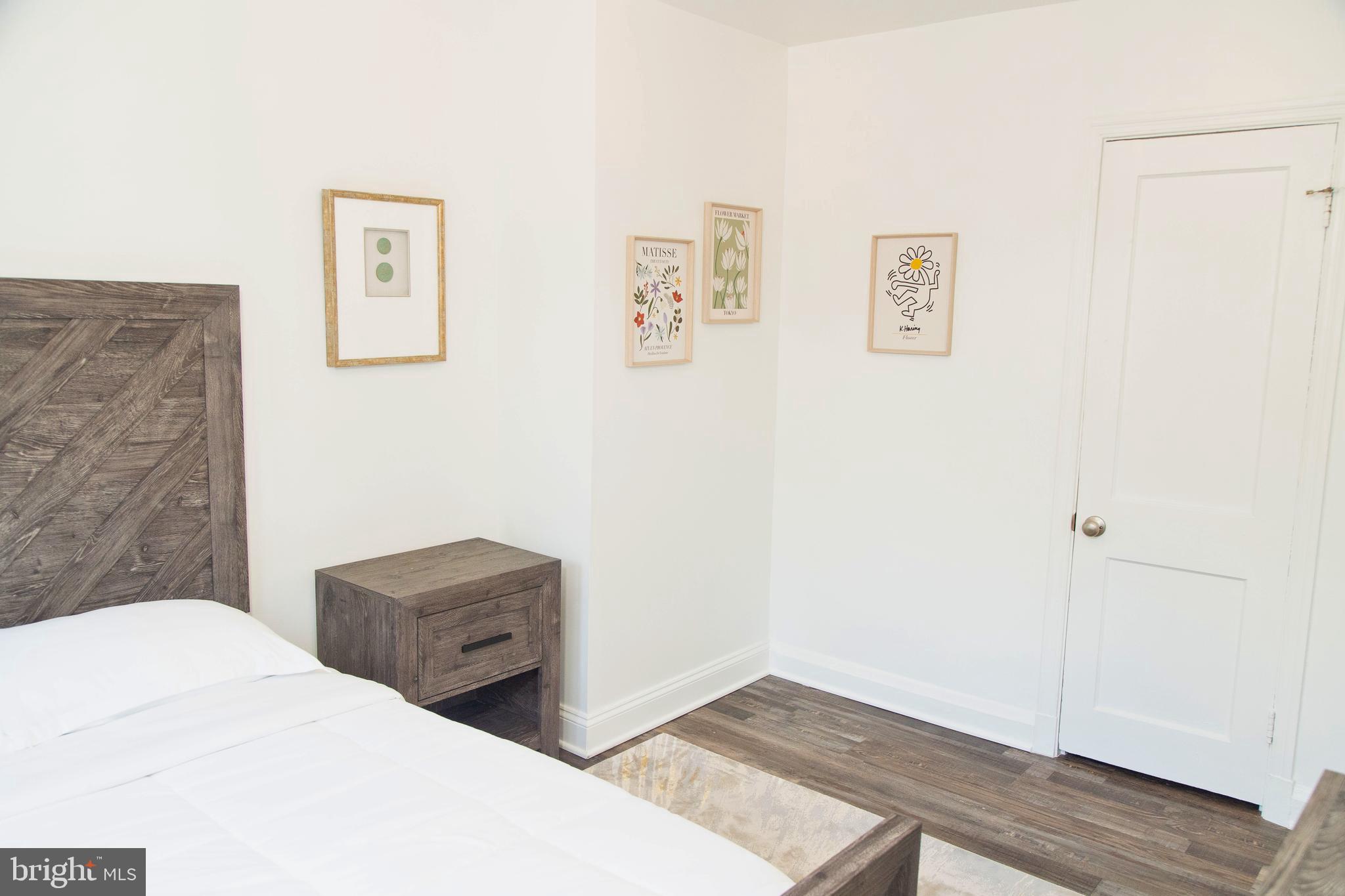 518 Random Road Baltimore, MD 21229 - Photo 17 of 29 a bedroom with bed and wall