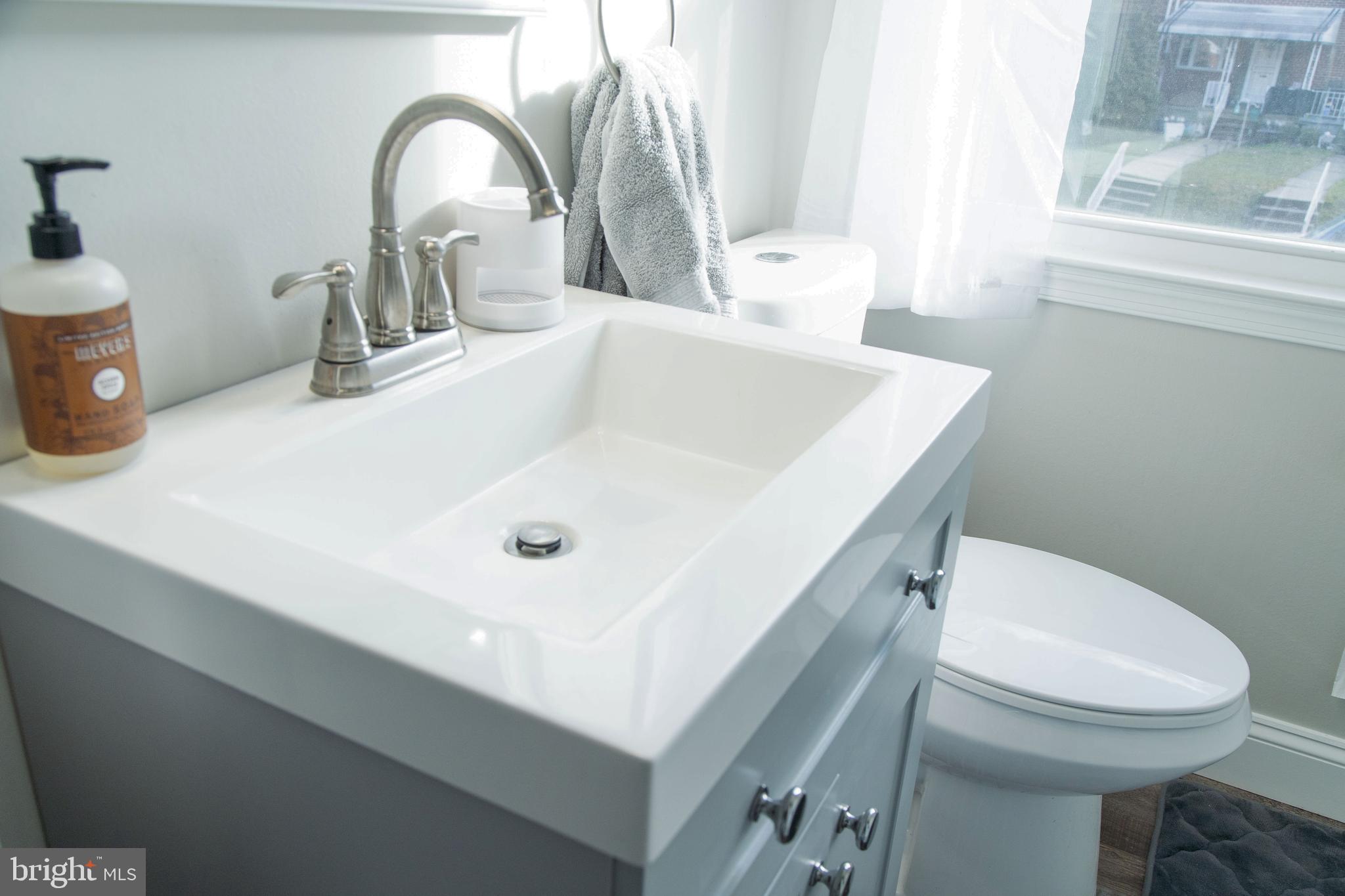 518 Random Road Baltimore, MD 21229 - Photo 21 of 29 a bathroom with a sink a toilet and a mirror