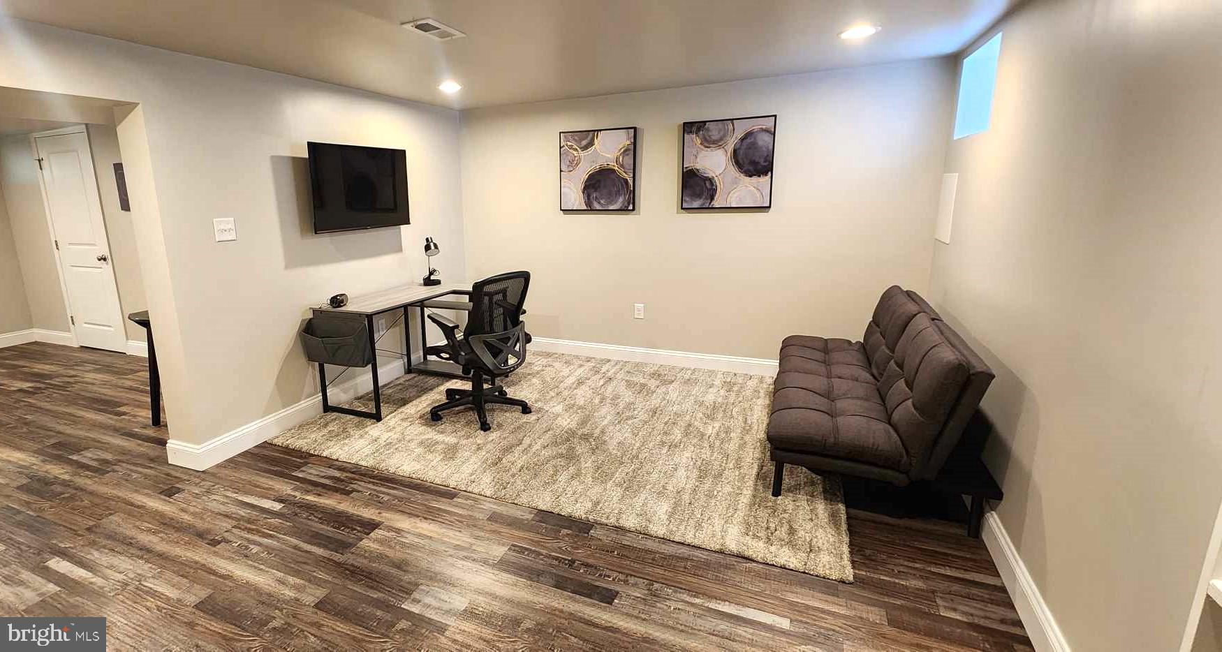 518 Random Road Baltimore, MD 21229 - Photo 24 of 29 a living room with furniture and a flat screen tv