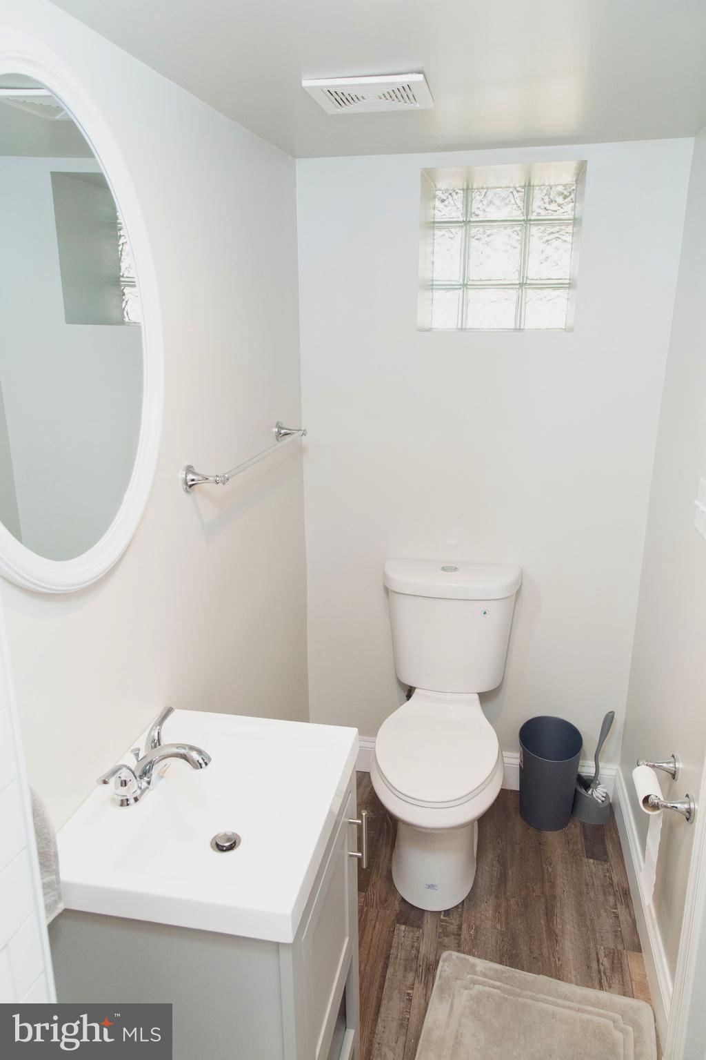 518 Random Road Baltimore, MD 21229 - Photo 25 of 29 a bathroom with a sink a toilet and a mirror
