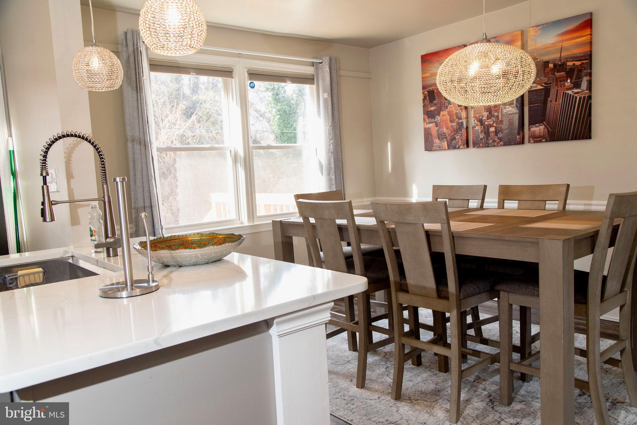 518 Random Road Baltimore, MD 21229 - Photo 5 of 29 a view of a dining room with furniture and chandelier