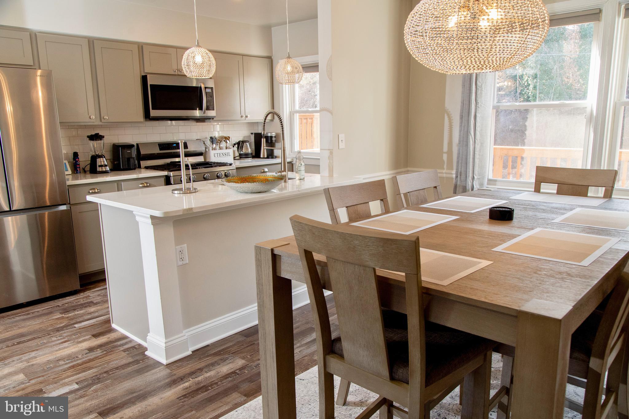 518 Random Road Baltimore, MD 21229 - Photo 6 of 29 a kitchen with a table chairs sink and microwave