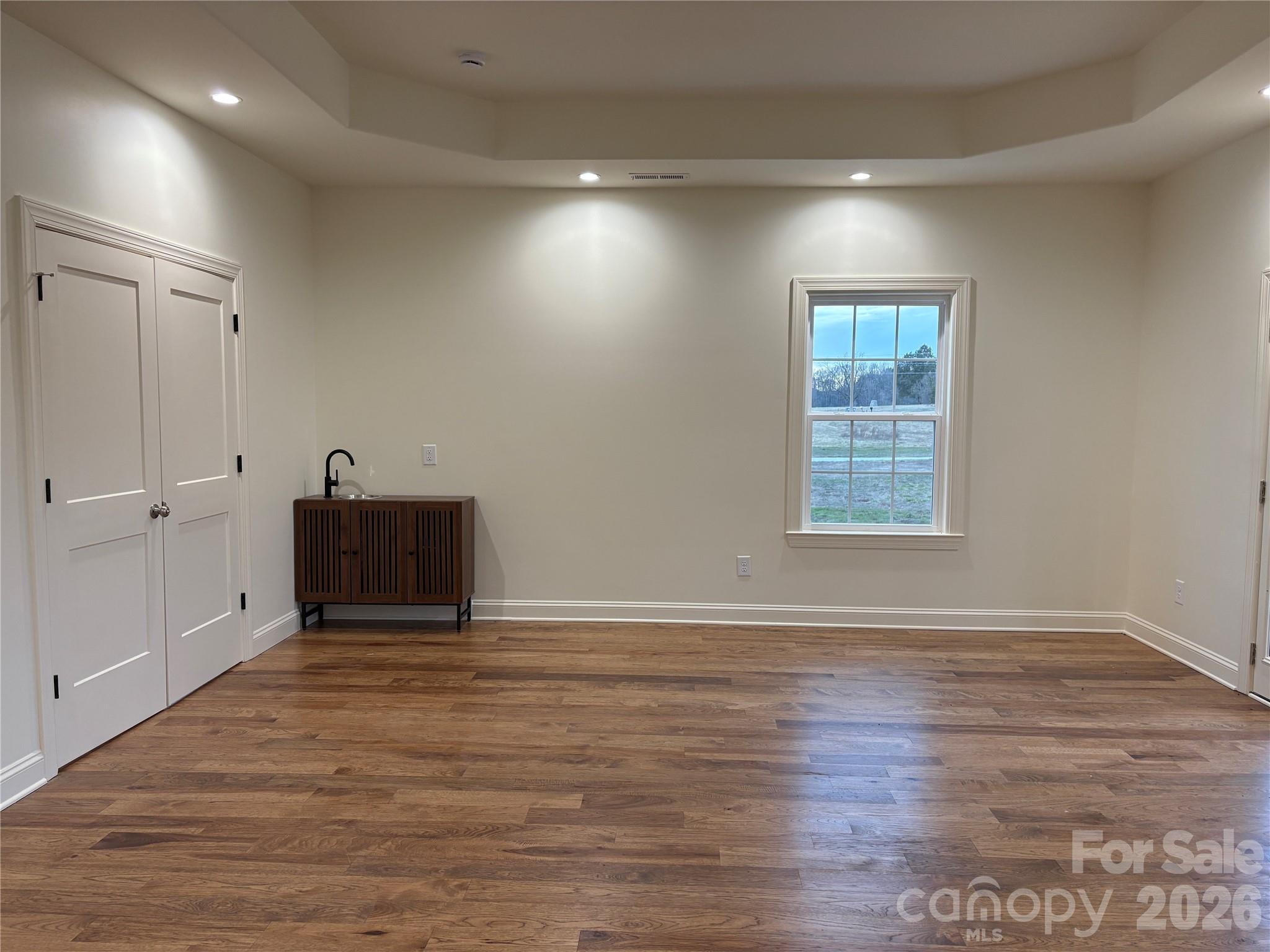 7217 Tesh Road, Unit 5 Monroe, NC 28110 - Photo 37 of 48 an empty room with wooden floor and windows