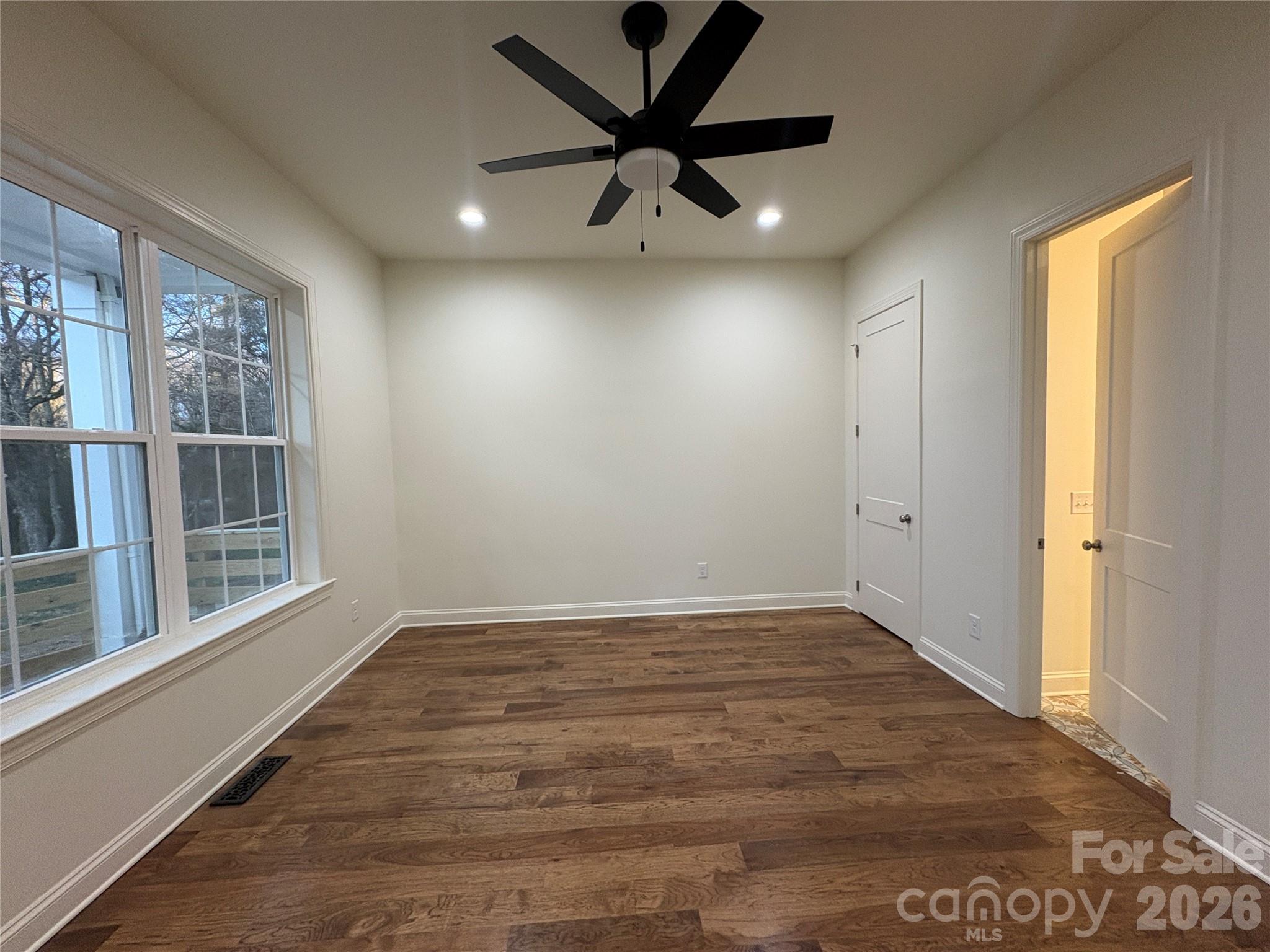 7217 Tesh Road, Unit 5 Monroe, NC 28110 - Photo 8 of 48 wooden floor in an empty room with a window