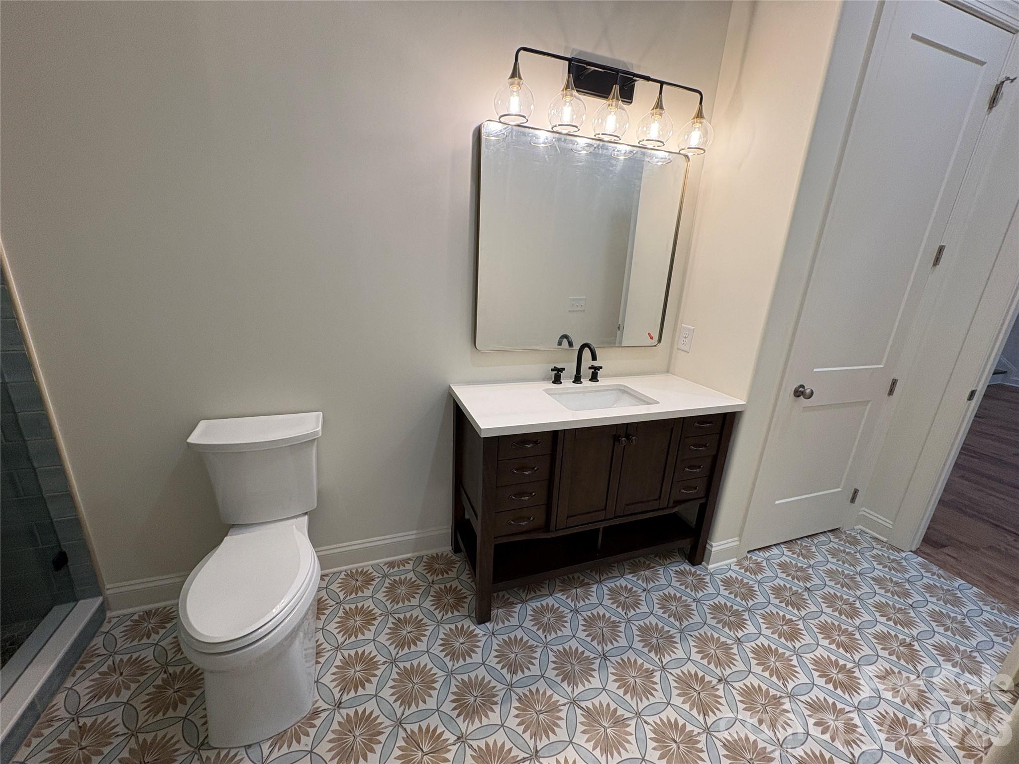 7217 Tesh Road, Unit 5 Monroe, NC 28110 - Photo 10 of 48 a bathroom with a toilet sink and mirror