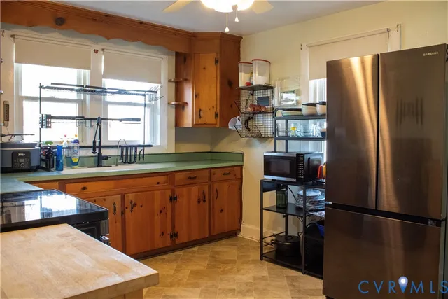 a kitchen with stainless steel appliances granite countertop a refrigerator and a sink