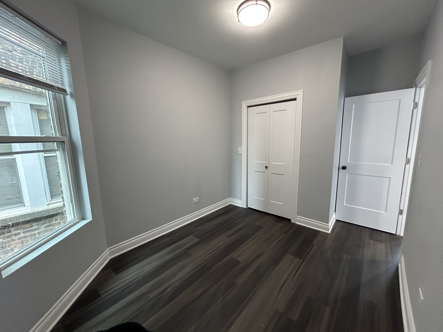 7940 South Carpenter Street, Unit 2 Chicago, IL 60620 - Photo 31 of 34 an empty room with wooden floor and windows