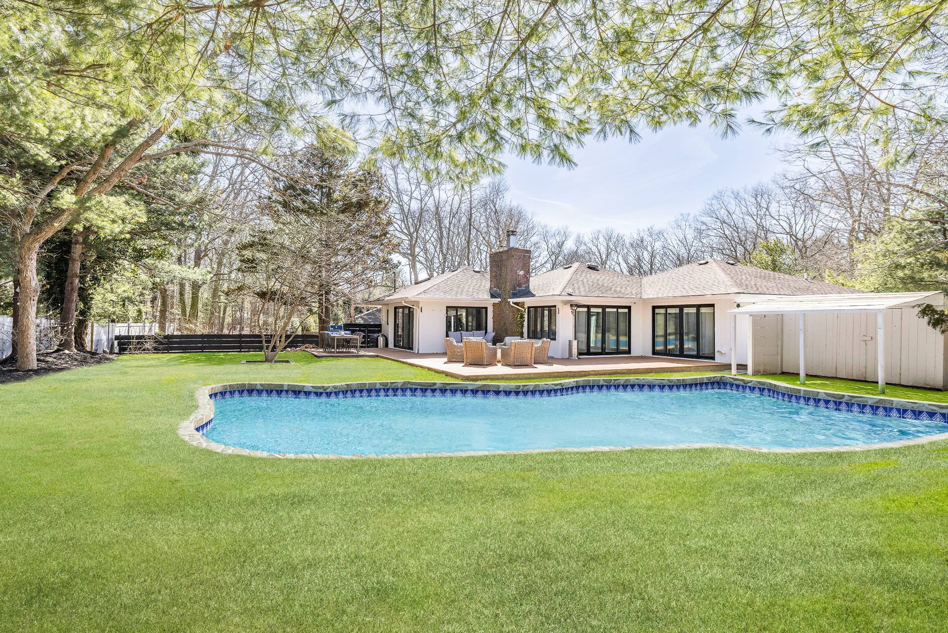 1 High Point Road East Hampton, NY 11937 - Photo 2 of 18 a white house with a large pool in front of it