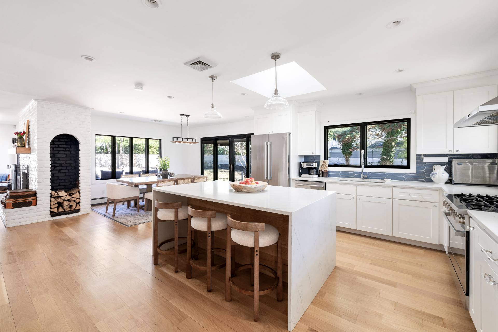 1 High Point Road East Hampton, NY 11937 - Photo 6 of 18 a kitchen with stainless steel appliances granite countertop a stove a sink a dining table and chairs with wooden floor