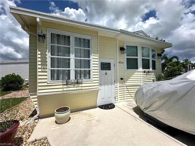 a view of a house with a yard and sitting space