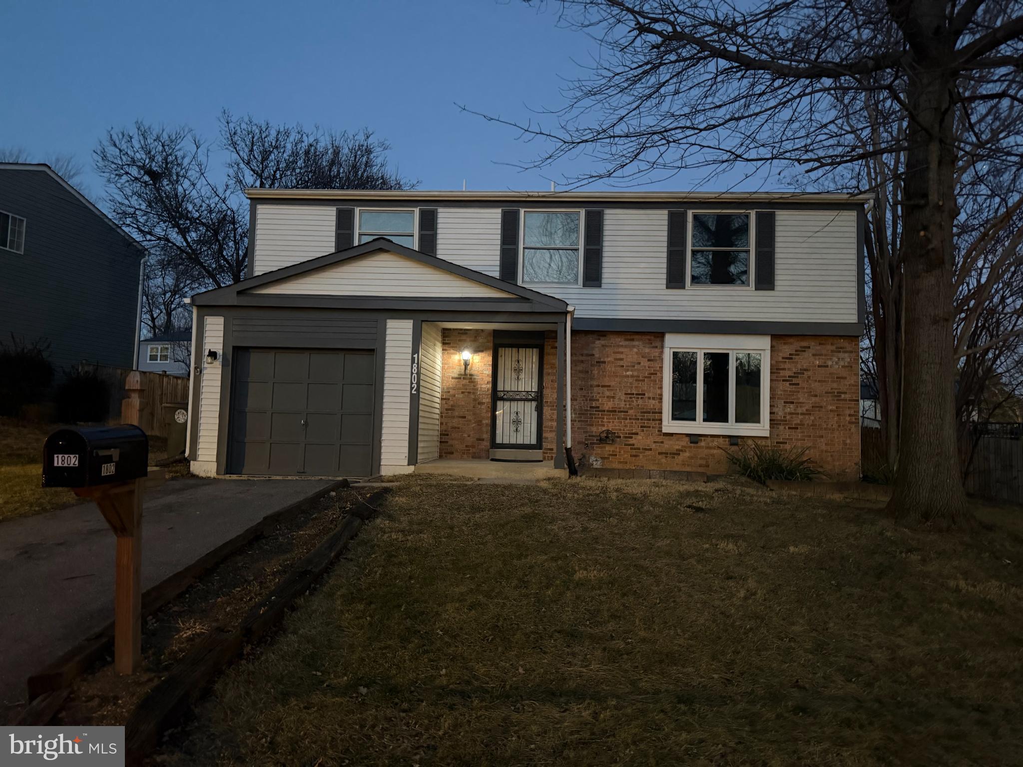 Charming two-story home at twilight.