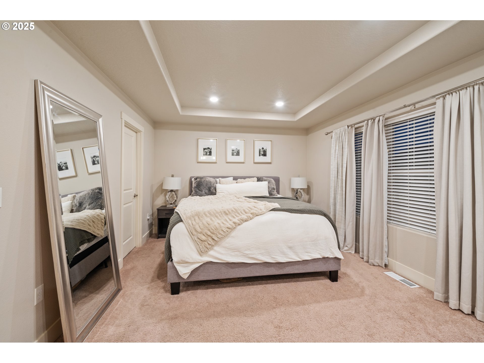 14224 Southwest 169th Avenue Portland, OR 97223 - Photo 16 of 37 a spacious bedroom with a bed a mirror and a window