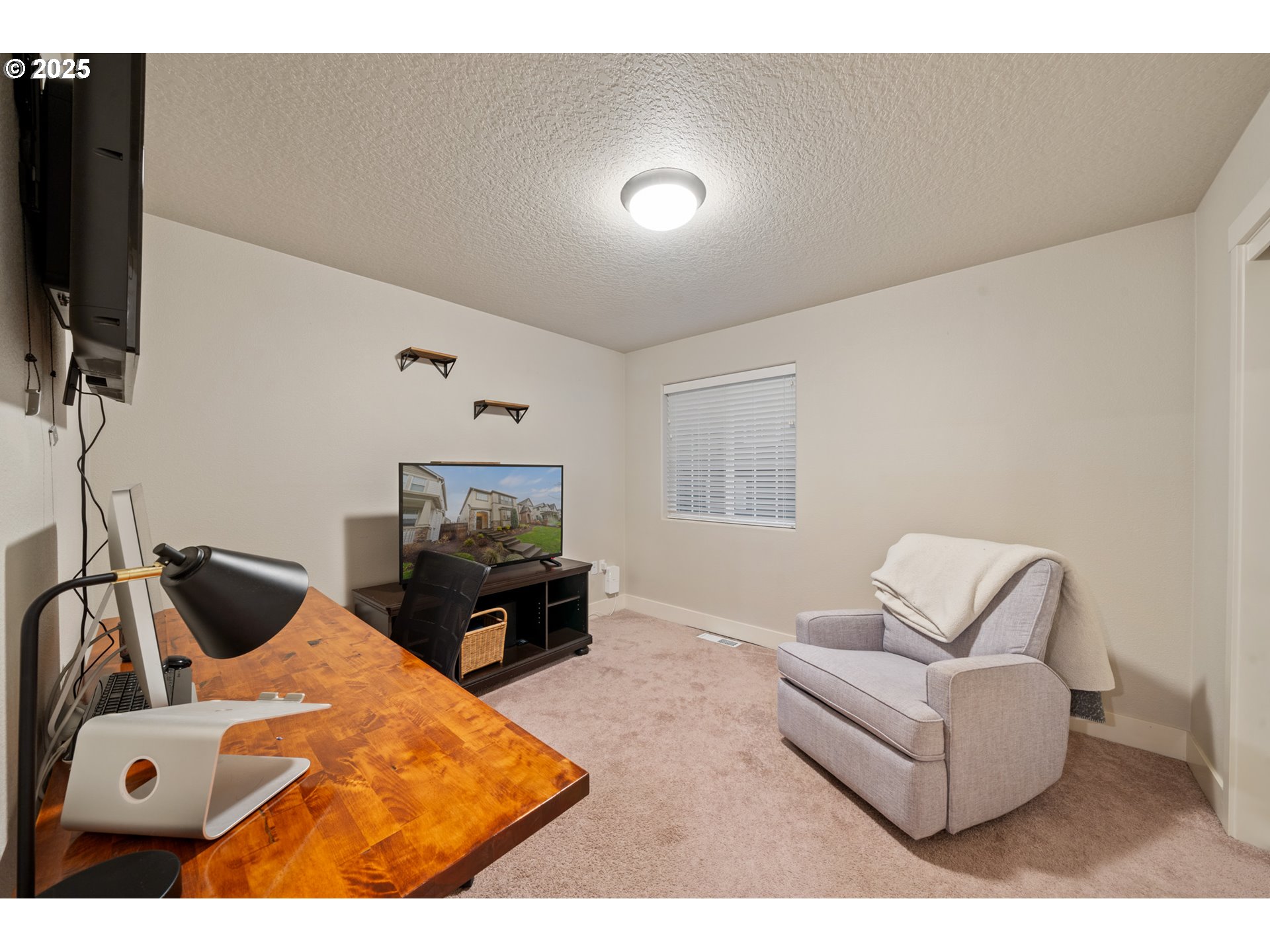 14224 Southwest 169th Avenue Portland, OR 97223 - Photo 22 of 37 a living room with furniture and a flat screen tv