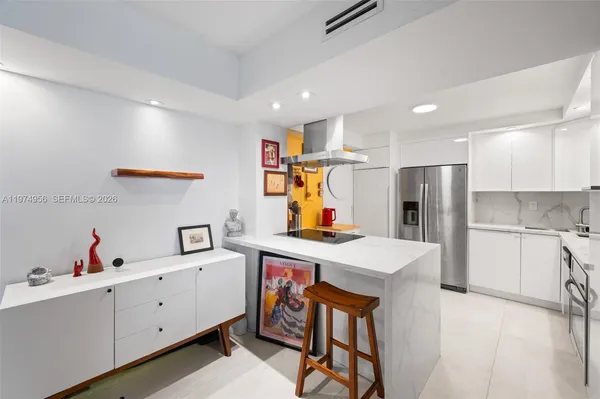 a kitchen with a sink appliances and cabinets
