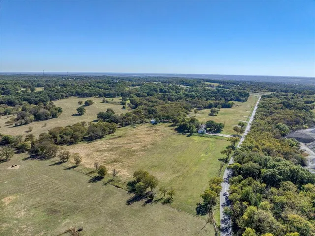 an aerial view of ocean with residential houses with outdoor space