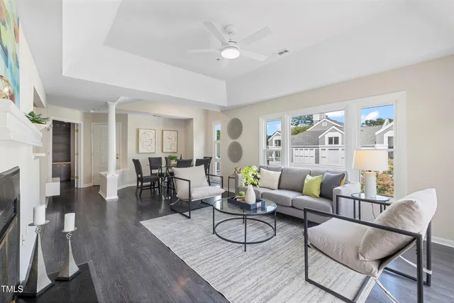 a living room with furniture and wooden floor