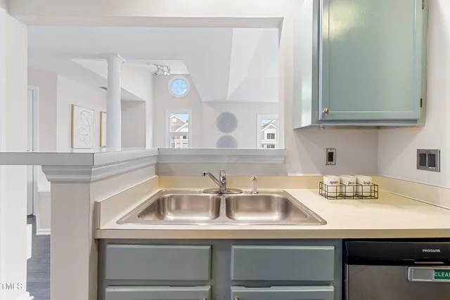 a kitchen with stainless steel appliances granite countertop a stove and a white cabinets