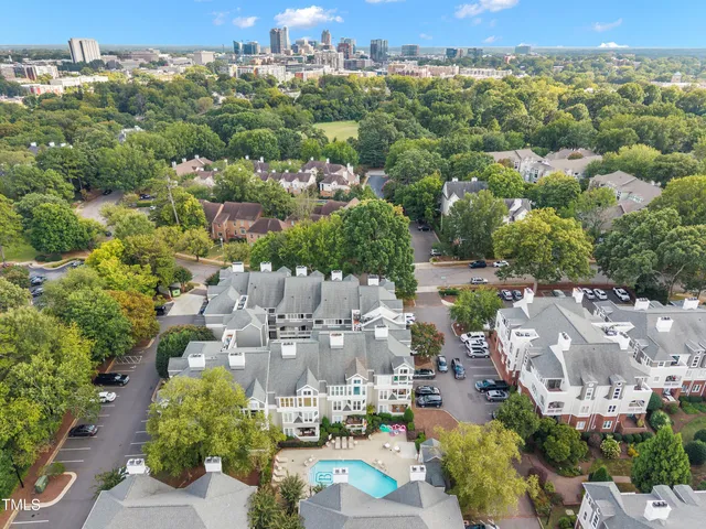 an aerial view of residential building with green space