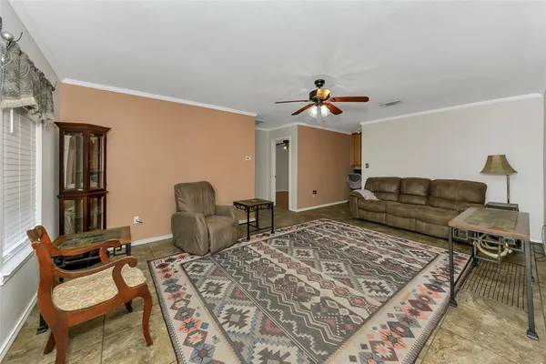 a living room with furniture rug and window