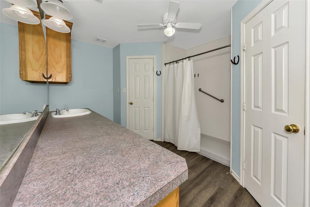 512 Allison Road Springtown, TX 76082 - Photo 17 of 32 a bathroom with a granite countertop sink and a mirror