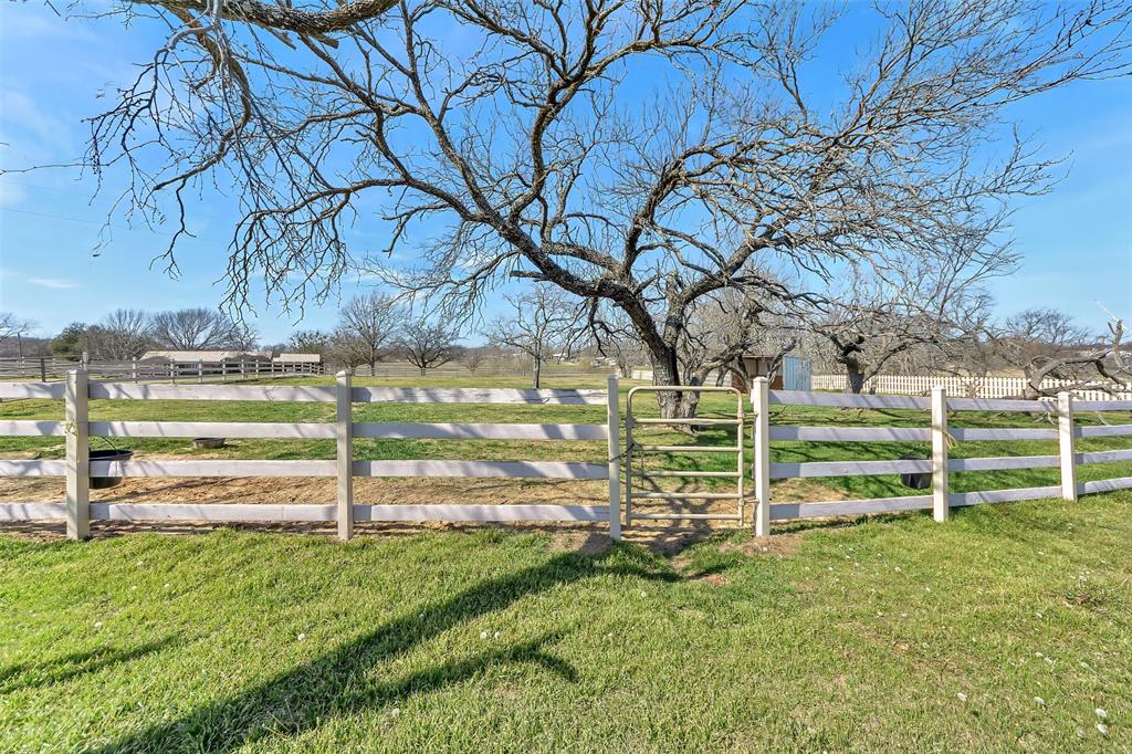 512 Allison Road Springtown, TX 76082 - Photo 6 of 32 a view of a yard with wooden fence