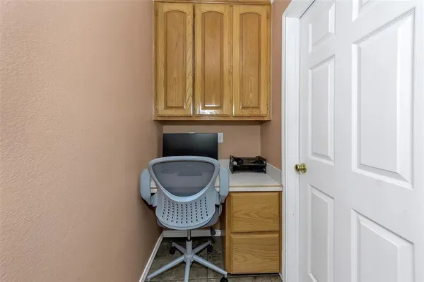 a bathroom with a chair and a window