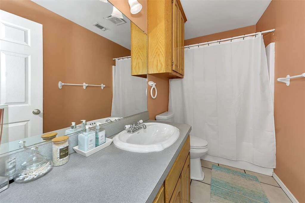 512 Allison Road Springtown, TX 76082 - Photo 8 of 32 a bathroom with a sink and a mirror