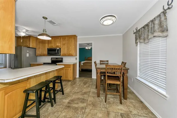 a dining room with furniture and window