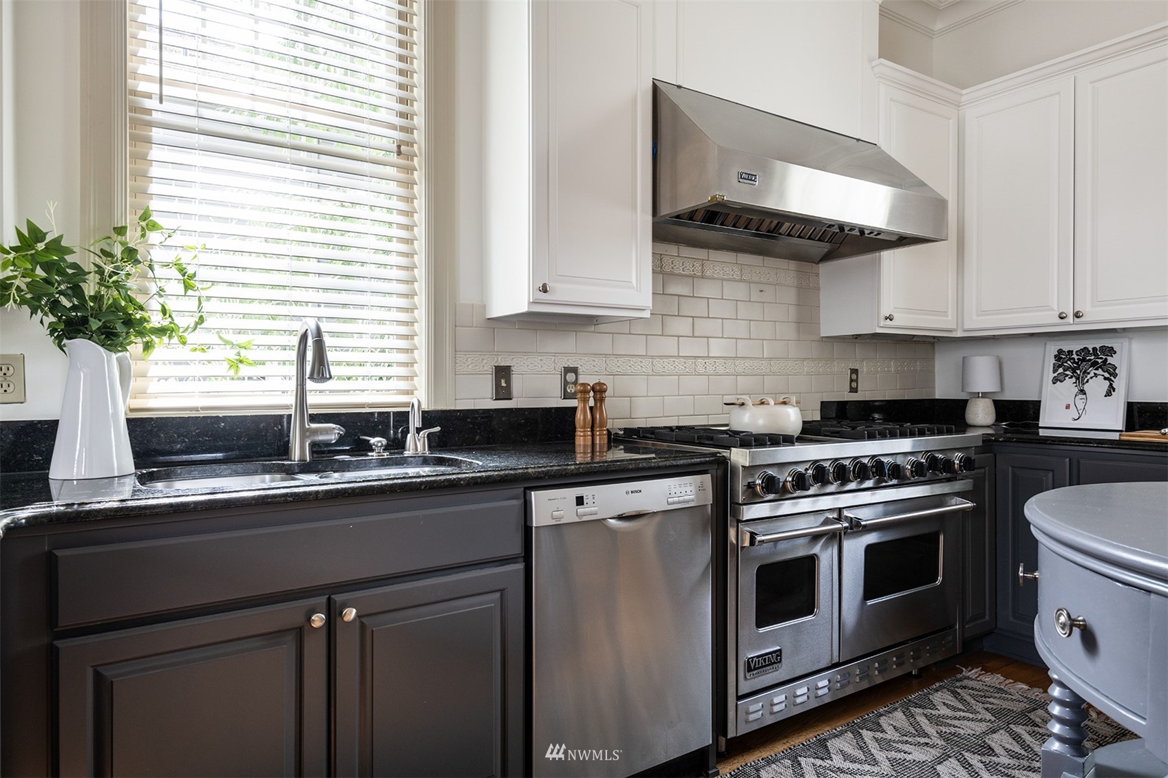 830 35th Avenue Seattle, WA 98122 - Photo 16 of 40 a kitchen with stainless steel appliances granite countertop a sink a stove and a window