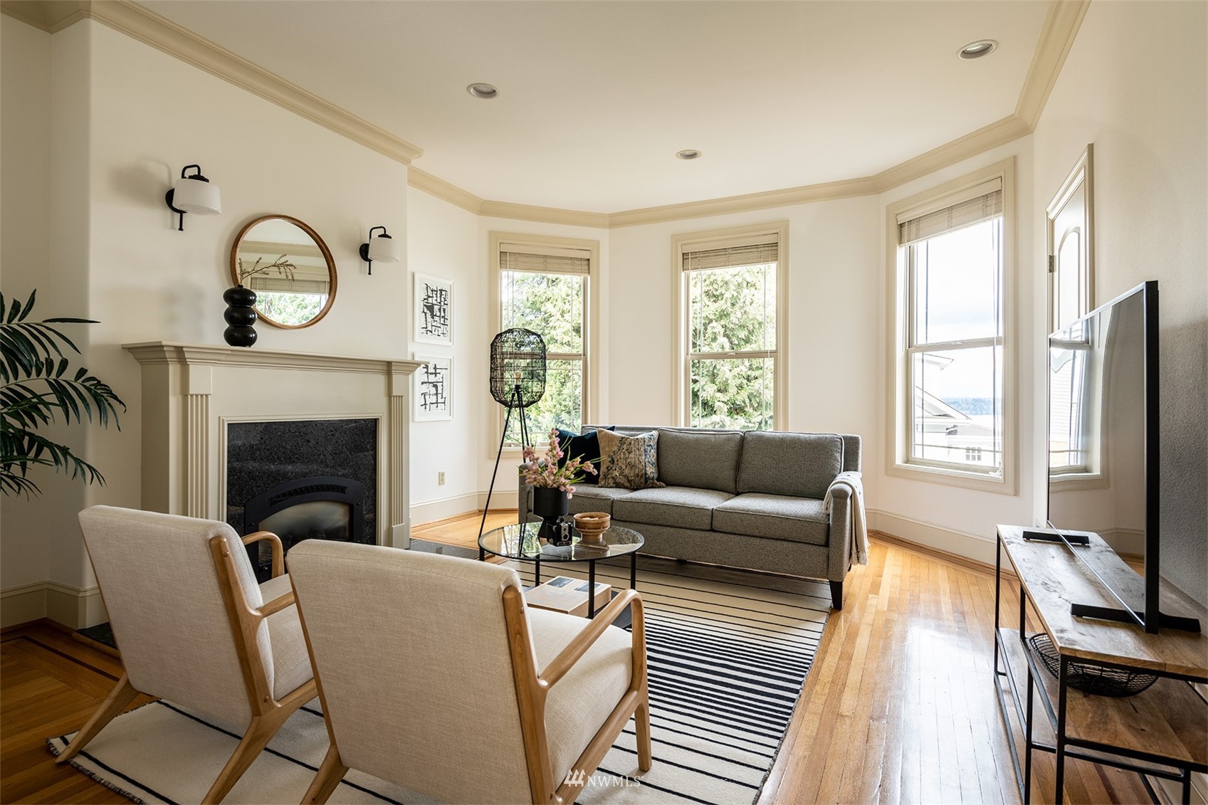 830 35th Avenue Seattle, WA 98122 - Photo 20 of 40 a living room with furniture a fireplace a flat screen tv and a large window