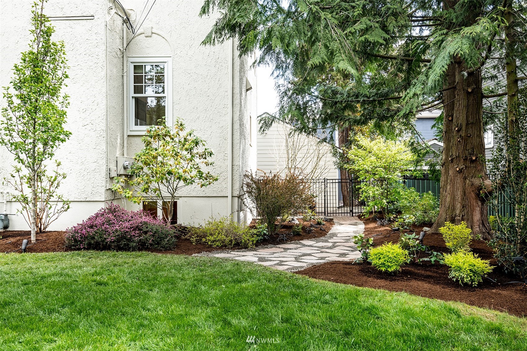 830 35th Avenue Seattle, WA 98122 - Photo 38 of 40 a garden with a bench and trees