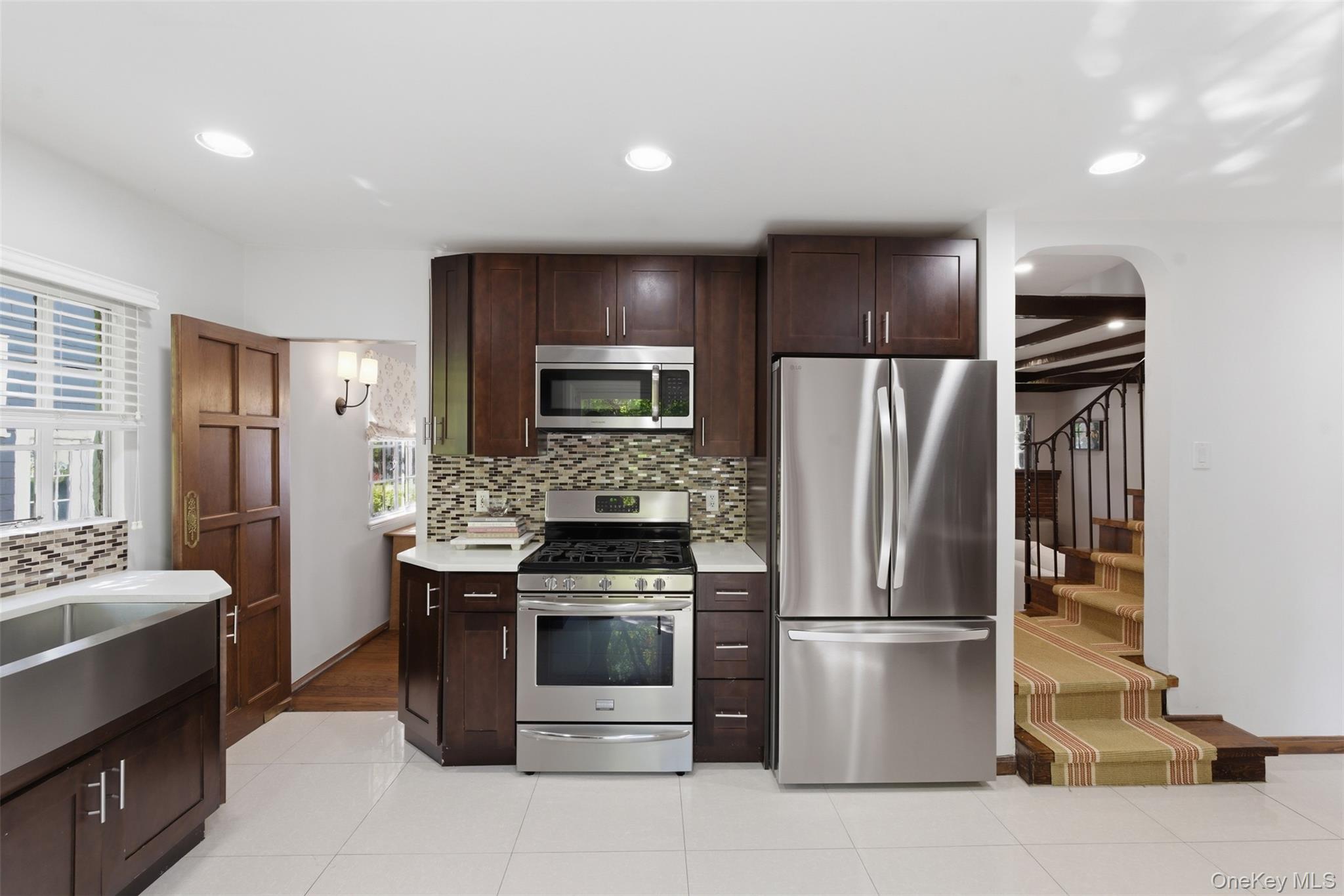 15 Kingsbury Road New Rochelle, NY 10804 - Photo 11 of 30 a kitchen with stainless steel appliances a refrigerator and a stove top oven