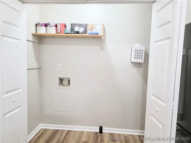 a view of a room with wooden floor and fan