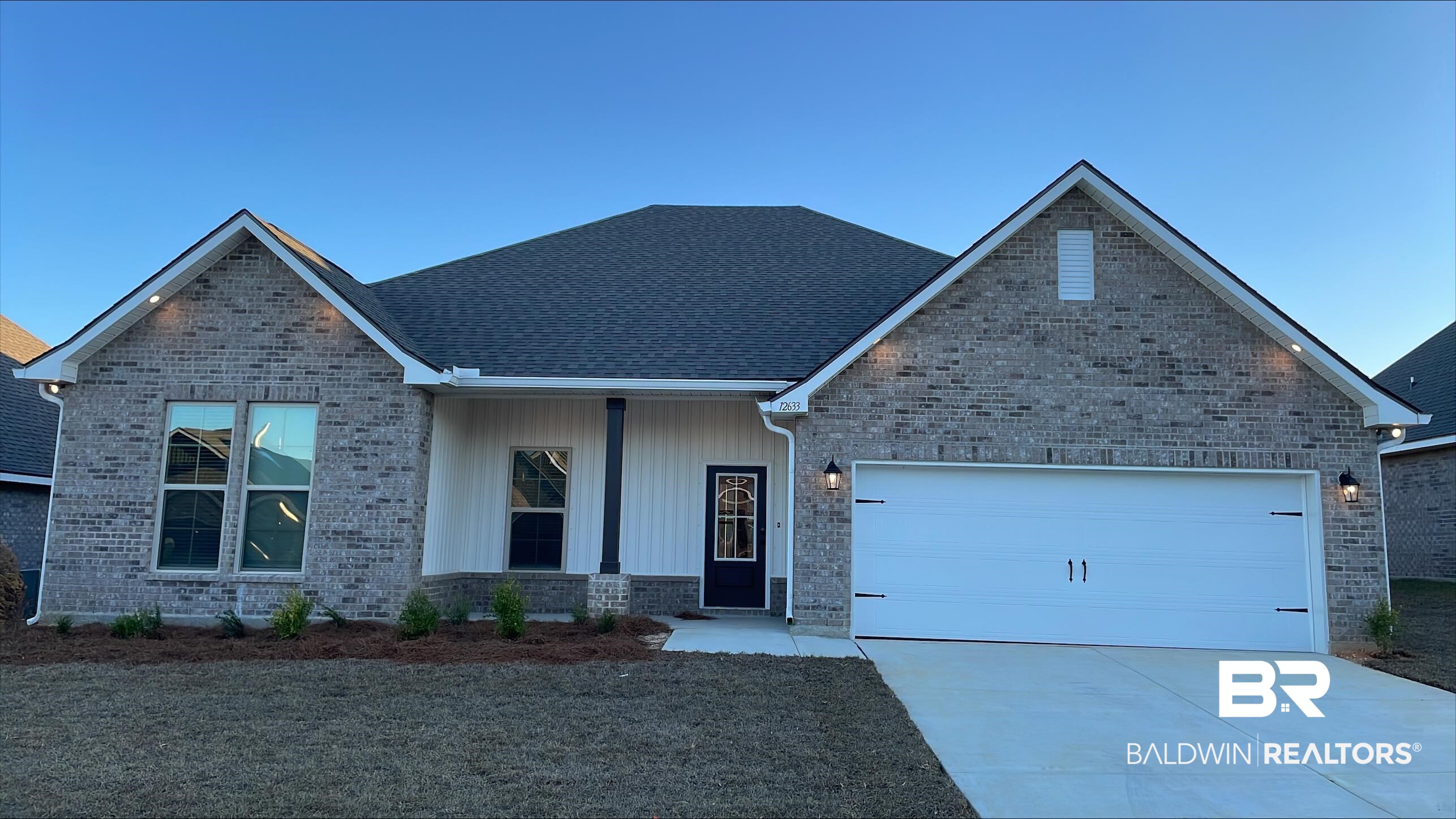 12633 Wagner Avenue Daphne, AL 36527 - Photo 1 of 3 View of front of property with a porch, a garage, driveway, and brick siding