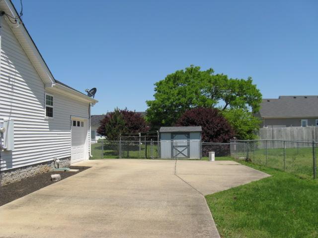 1129 Silverado Way Murfreesboro, TN 37130 - Photo 19 of 20 View of driveway with extra parking, storage building, and fenced yard.