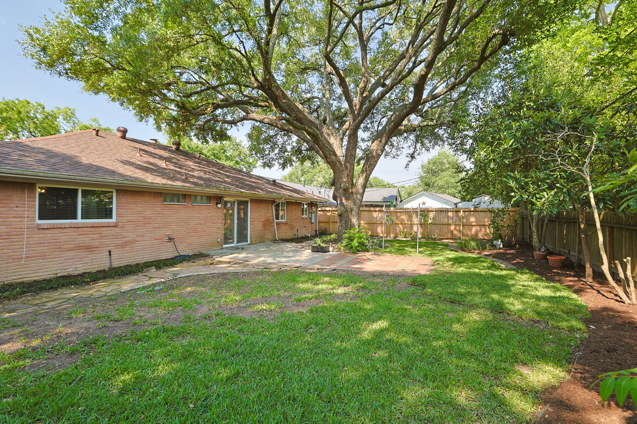 5410 Indigo Street Houston, TX 77096 - Photo 25 of 30 Great view of the expansive backyard with great big shade tree.
