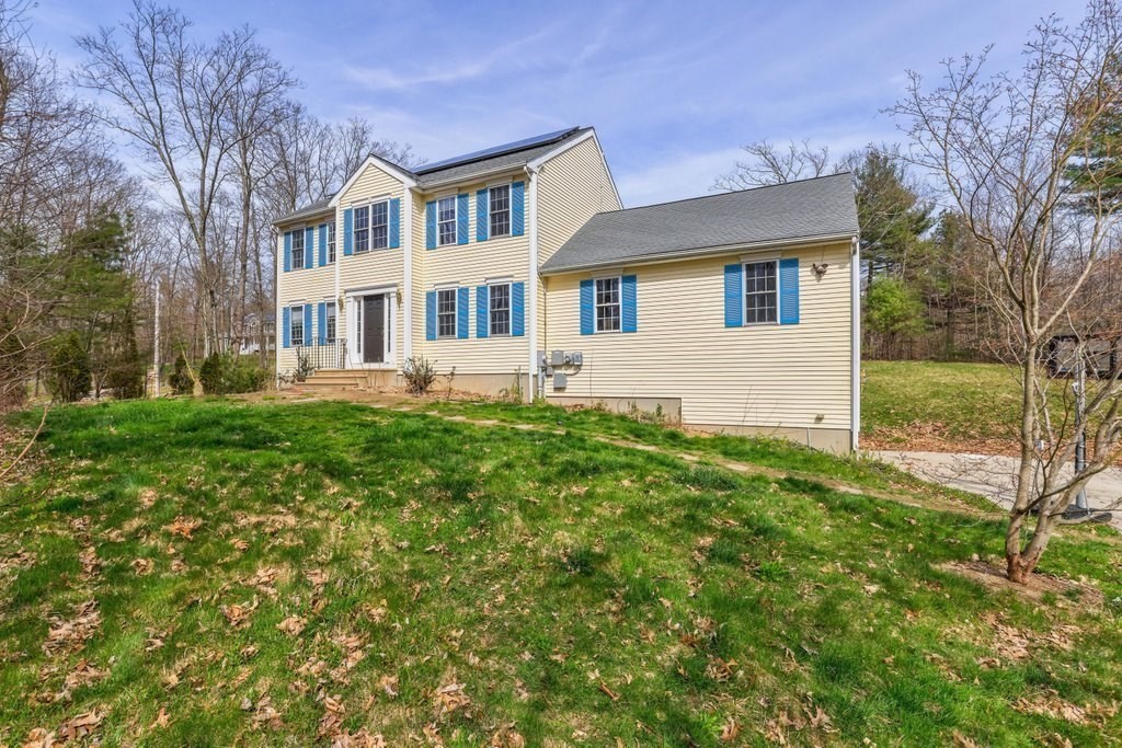 53 Baker Pond Road Charlton, MA 01507 - Photo 1 of 27 a front view of a house with a yard