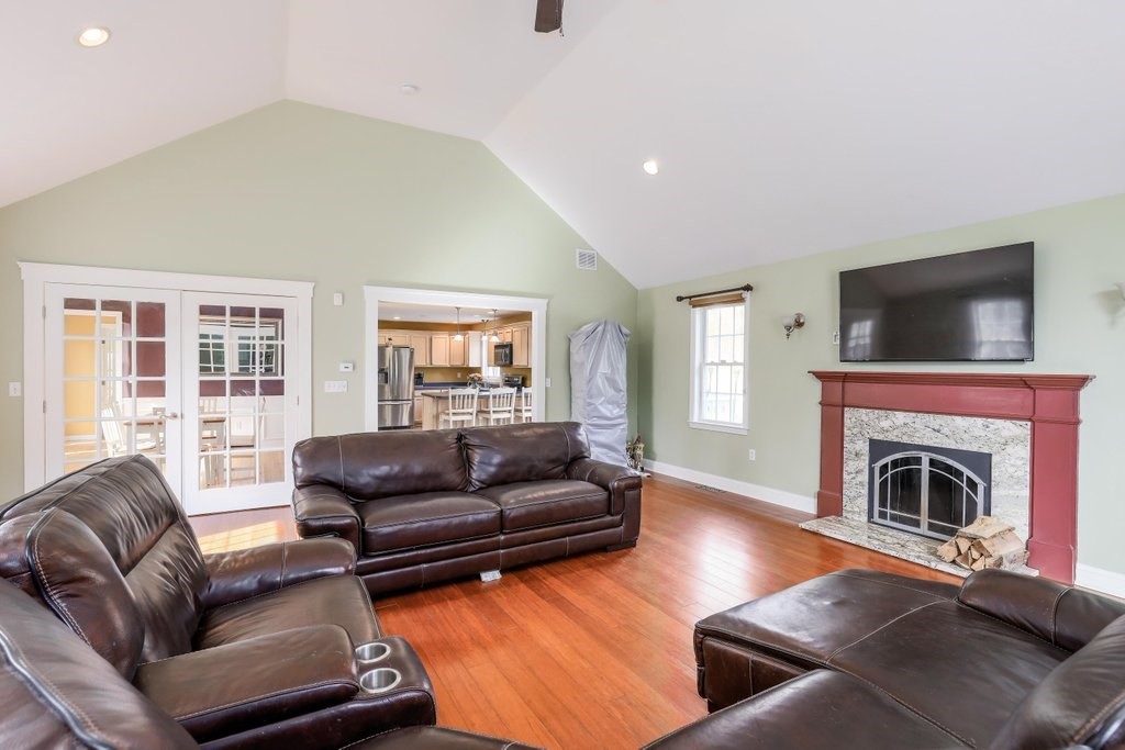 53 Baker Pond Road Charlton, MA 01507 - Photo 15 of 27 a living room with furniture flat screen tv and a fireplace