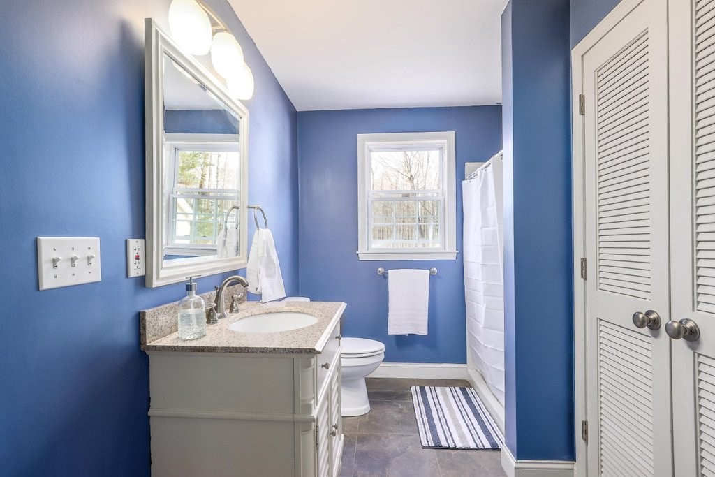 53 Baker Pond Road Charlton, MA 01507 - Photo 17 of 27 a bathroom with a sink toilet and a mirror