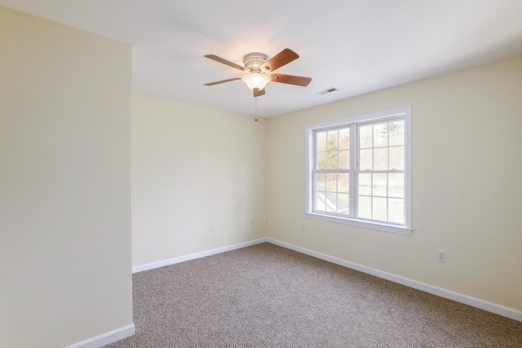 53 Baker Pond Road Charlton, MA 01507 - Photo 19 of 27 an empty room with windows and fan