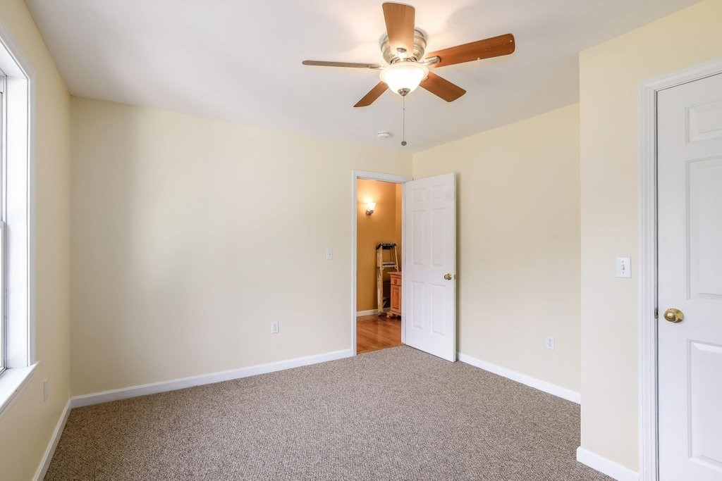 53 Baker Pond Road Charlton, MA 01507 - Photo 20 of 27 an empty room with a window and a fan